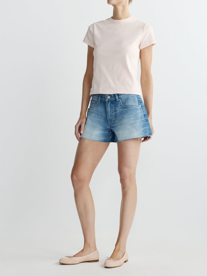 DL1961 women's Abby Relaxed low-rise jean shorts in medium blue 'Avenue', three-quarter view on model.