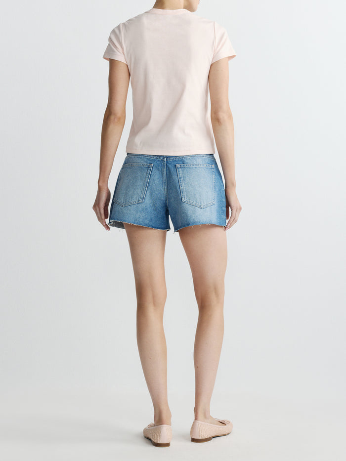 DL1961 women's Abby Relaxed low-rise jean shorts in medium blue 'Avenue', back view on model.