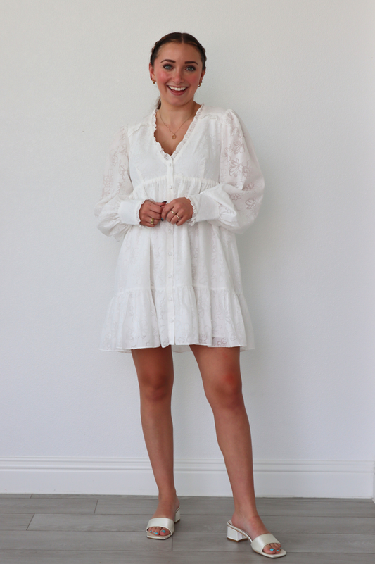 girl wearing white long sleeve floral dress