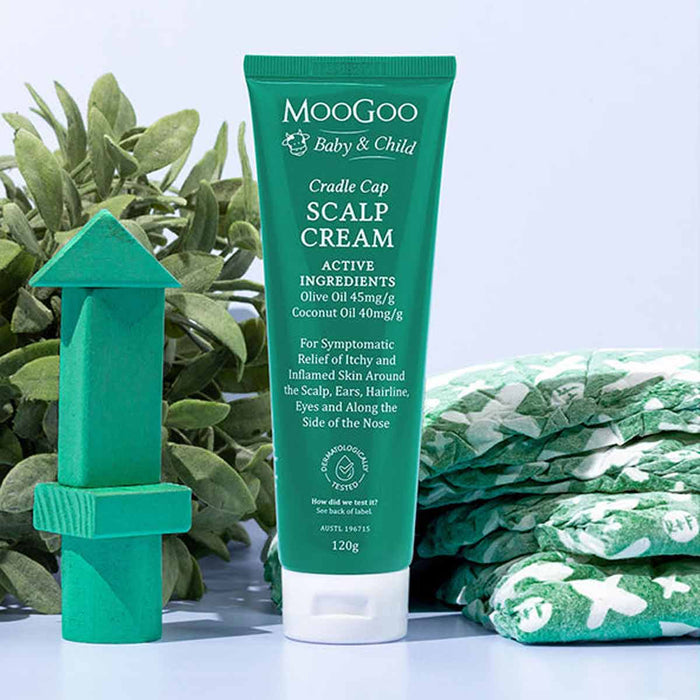 MooGoo Cradle Cap Scalp Cream with green packaging and text on a light blue background.