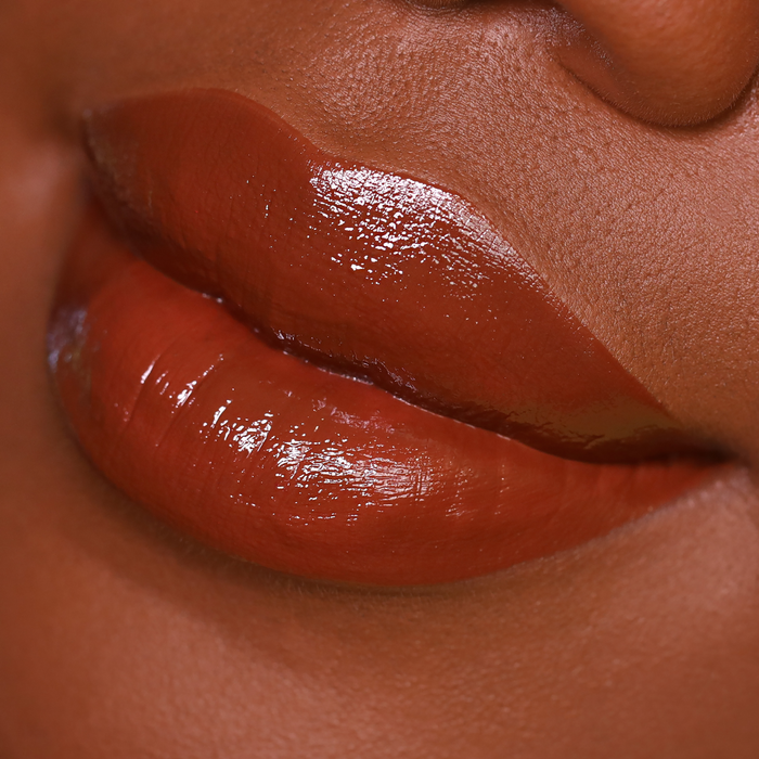 Bear with Me rich brown lipstick on lips, deep skin tone close-up