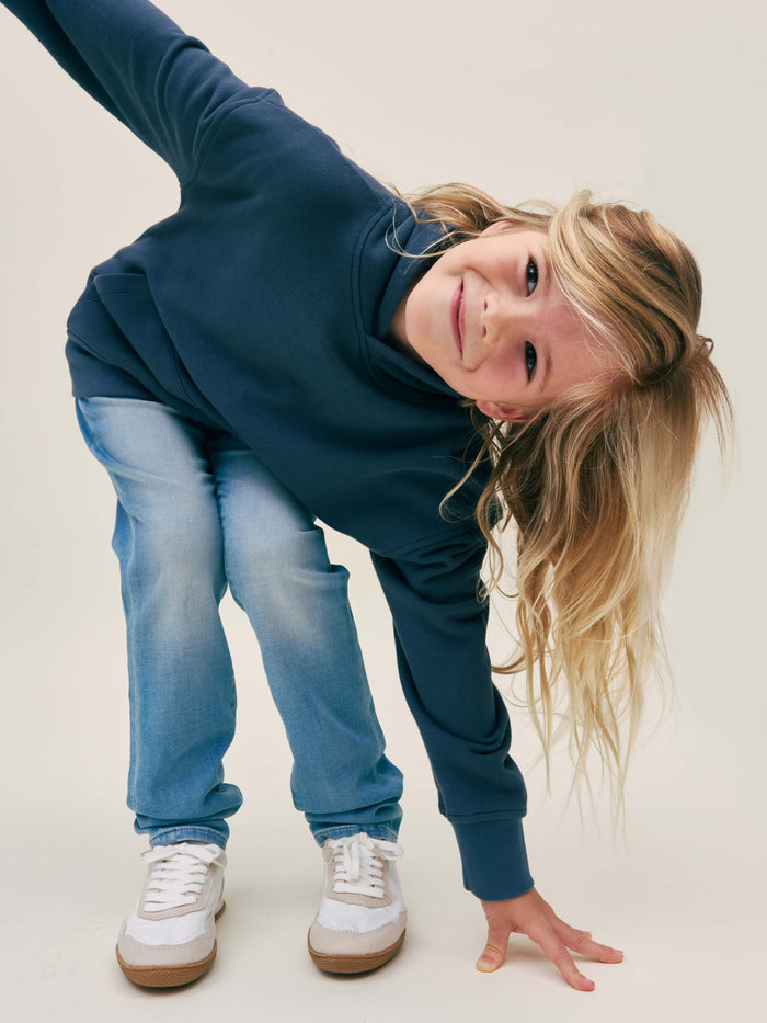 DL1961 boys' Brady Slim jeans in light blue knit denim 'Ramer', on child model in playful pose.