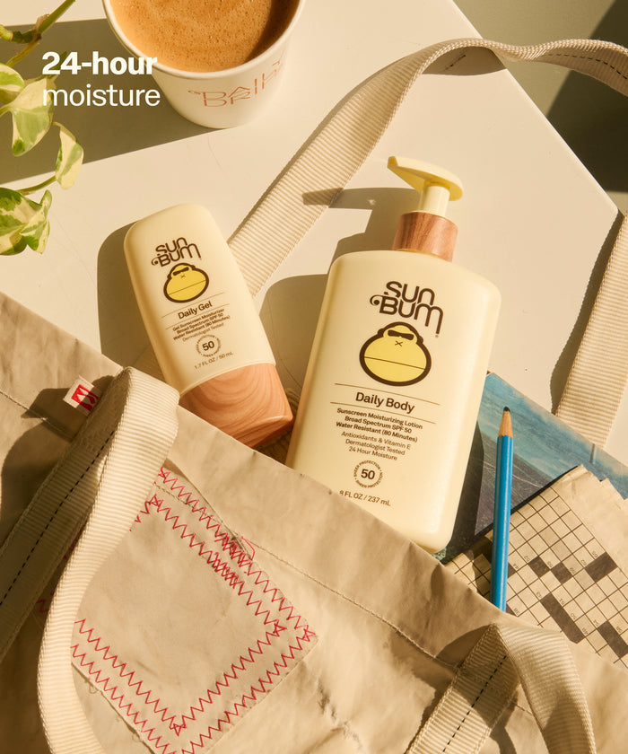 Sun Bum Daily Body + Face Gel Bundle with SPF 50 lotion and gel packed in a beige tote bag on a table. 24 hour moisture