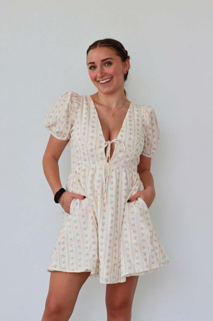 girl wearing cream floral dress