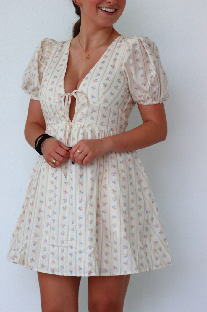 girl wearing cream floral dress