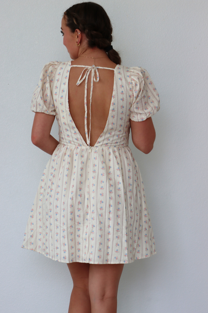 girl wearing cream floral dress