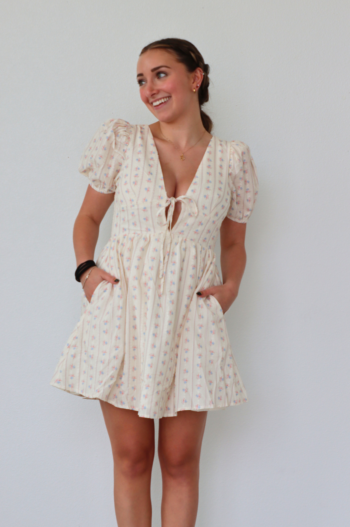 girl wearing cream floral dress