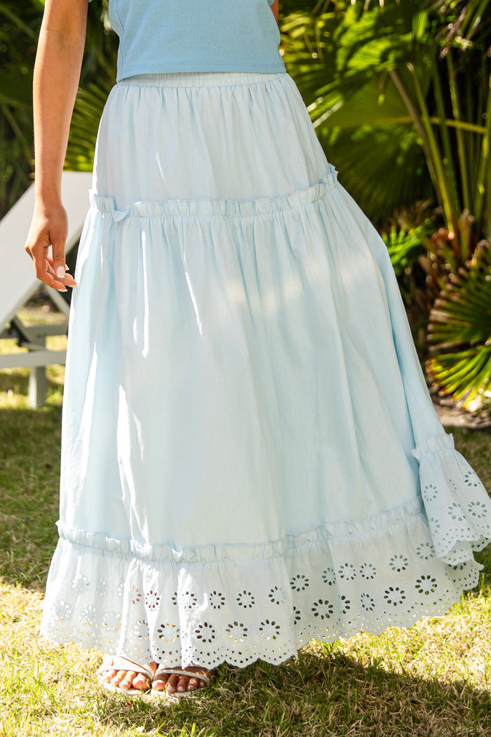 Light blue lace-trim maxi skirt in garden setting