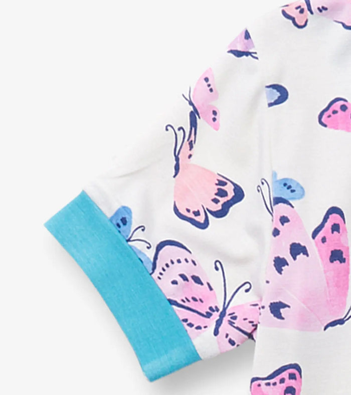 Closeup of Hatley girls bamboo pajama sleeve with butterfly print and aqua cuff detail.