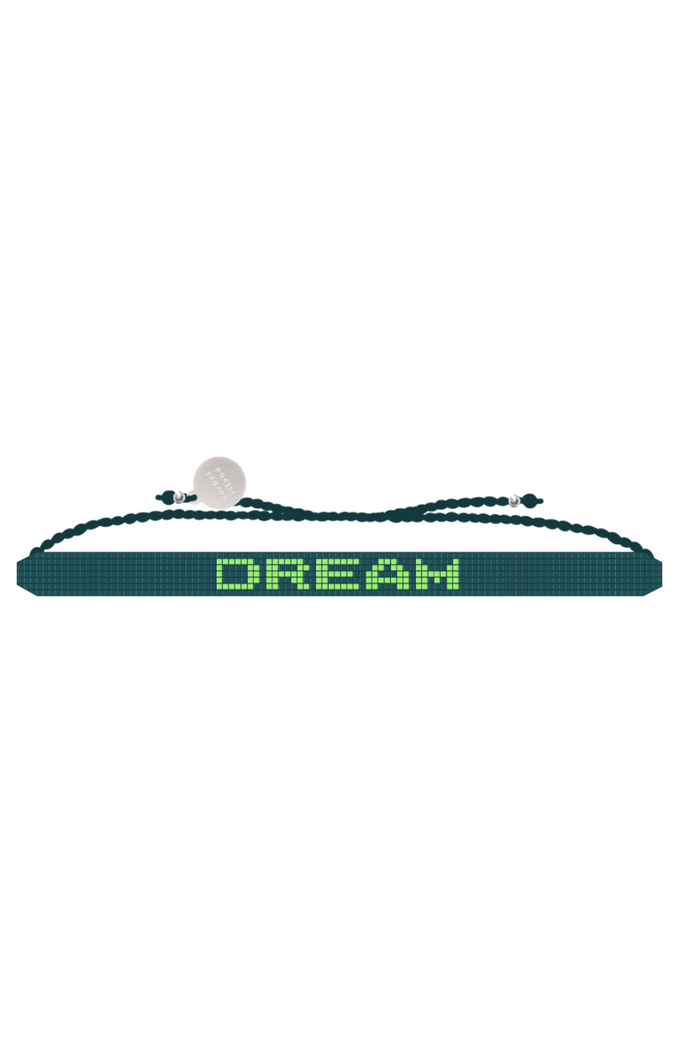 Necklace with 'DREAM' on a green cord against a white background
