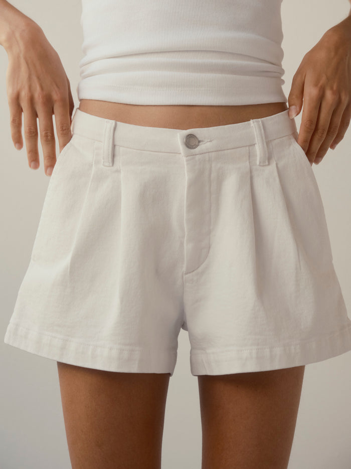DL1961 women's Isabel Relaxed jean shorts in white, close-up of pleated front and belt loops.