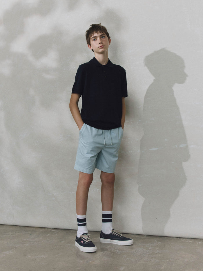 DL1961 boys' Jackson Short in pale blue 'Sky Blue', front view on child model styled with a black polo.
