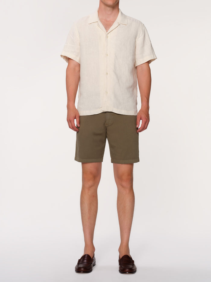 DL1961 men's Jake chino short in olive green 'Belfast', front view on model with cream camp shirt and loafers.