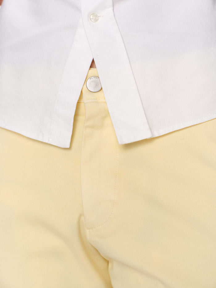 DL1961 men's Jake chino short in pale yellow 'Citron', close-up of front pocket and button waistband.