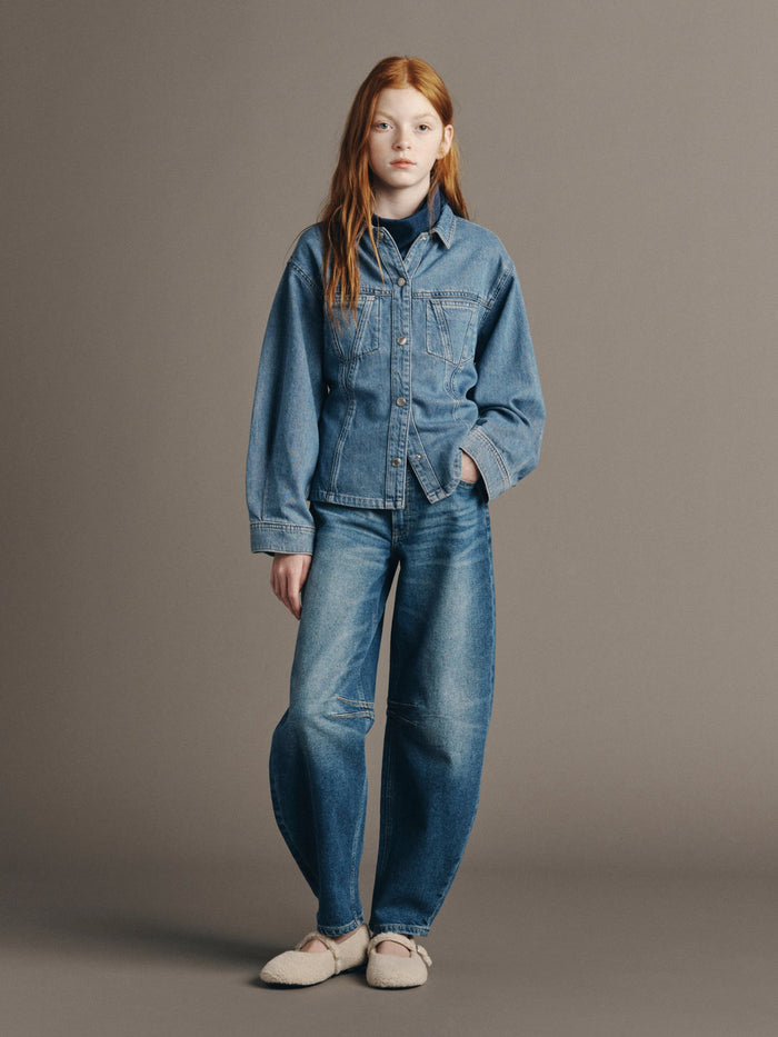 DL1961 girls' Kenzy barrel jeans in medium blue 'North Current', worn with a denim shirt, full-length front
