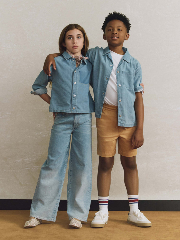 DL1961 girls' Lily Wide Leg jeans in light blue 'Prairie' on child model in denim shirt, front view