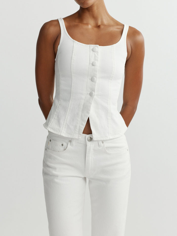 DL1961 women's Lisa top in white 'White', close-up front view on model, button-front denim tank with white jeans.