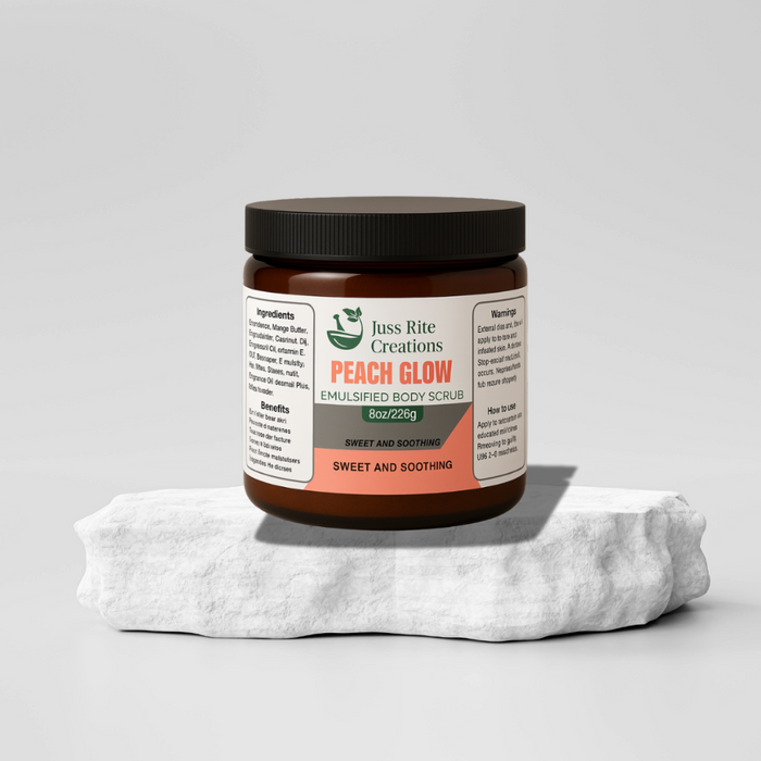 Jar of 'Peach Glow' emulsified body scrub with a white towel on a light gray background