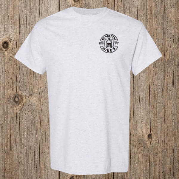 Fort Denaud Beard and Skin grey cotton t-shirt with Moonshine Mike's Beard Oil circular badge graphic on the chest.