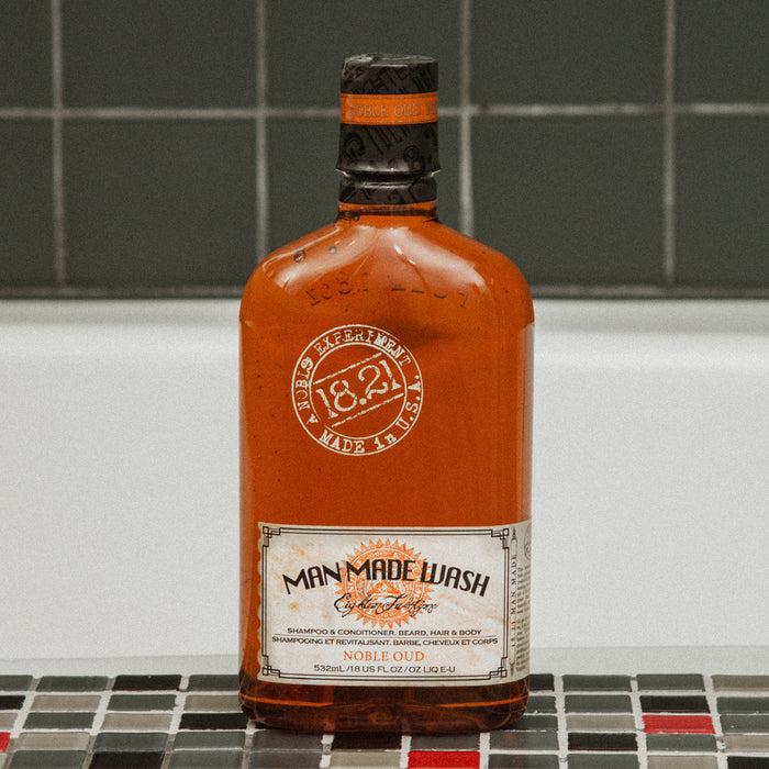 Bottle of Man Made Wash Noble Oud on a tiled surface
