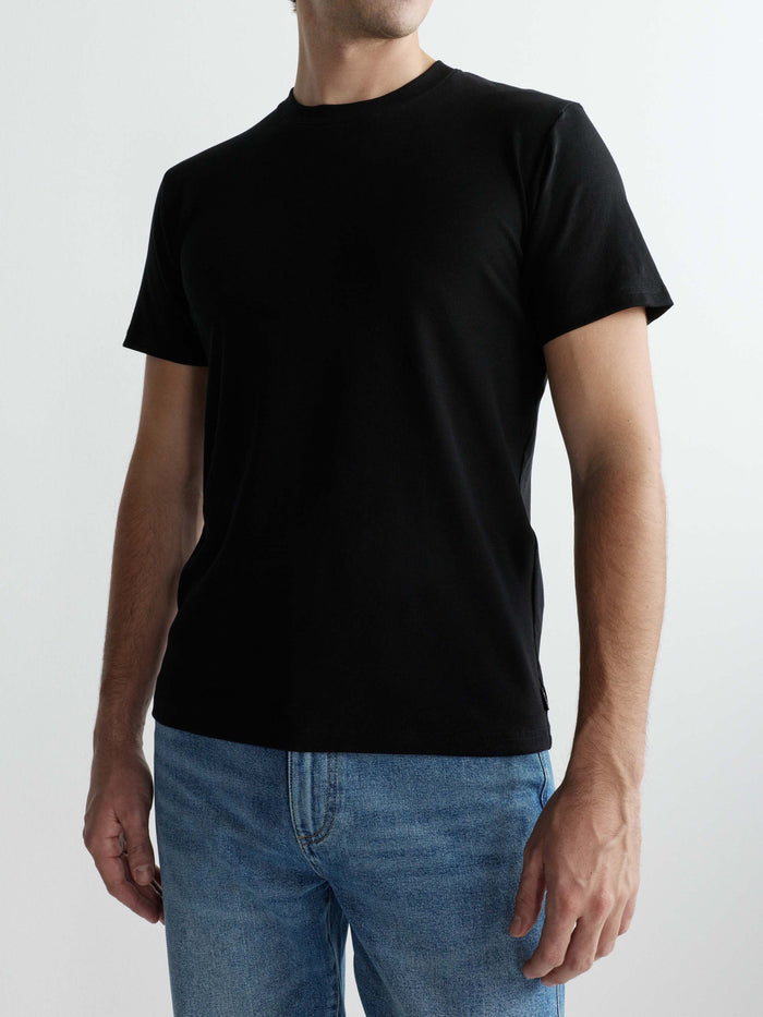 DL1961 men's ribbed crewneck tee in black 'Black', front close-up on-model with blue jeans.