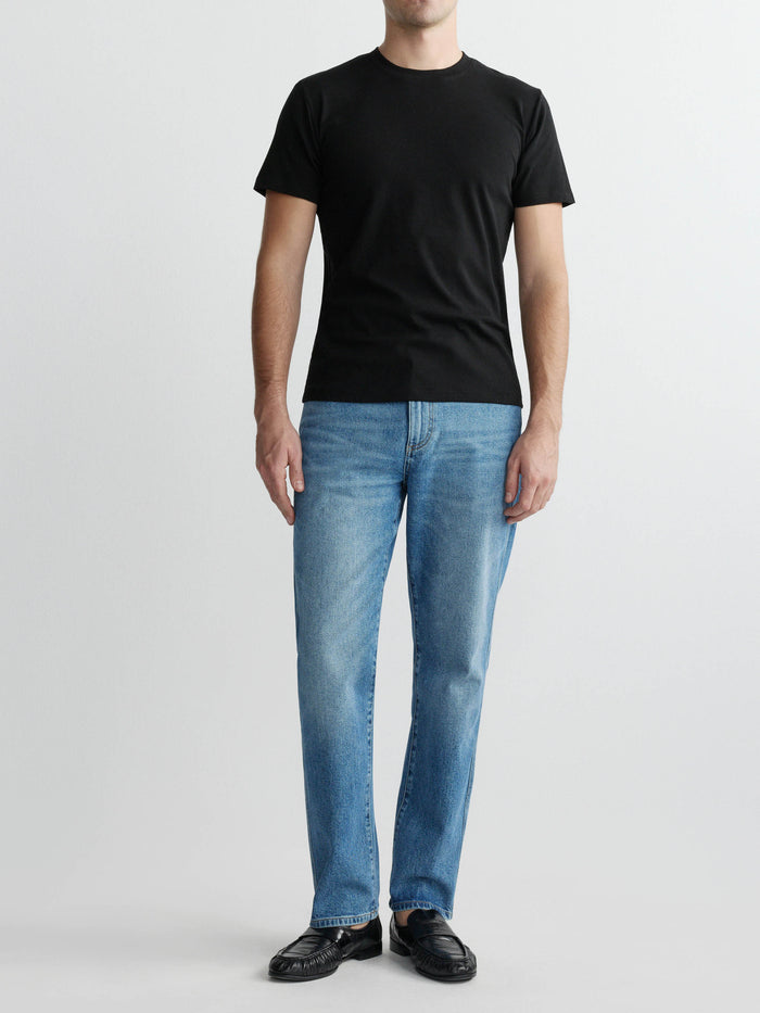 DL1961 men's ribbed crewneck tee in black 'Black', full-length front on-model with blue jeans.