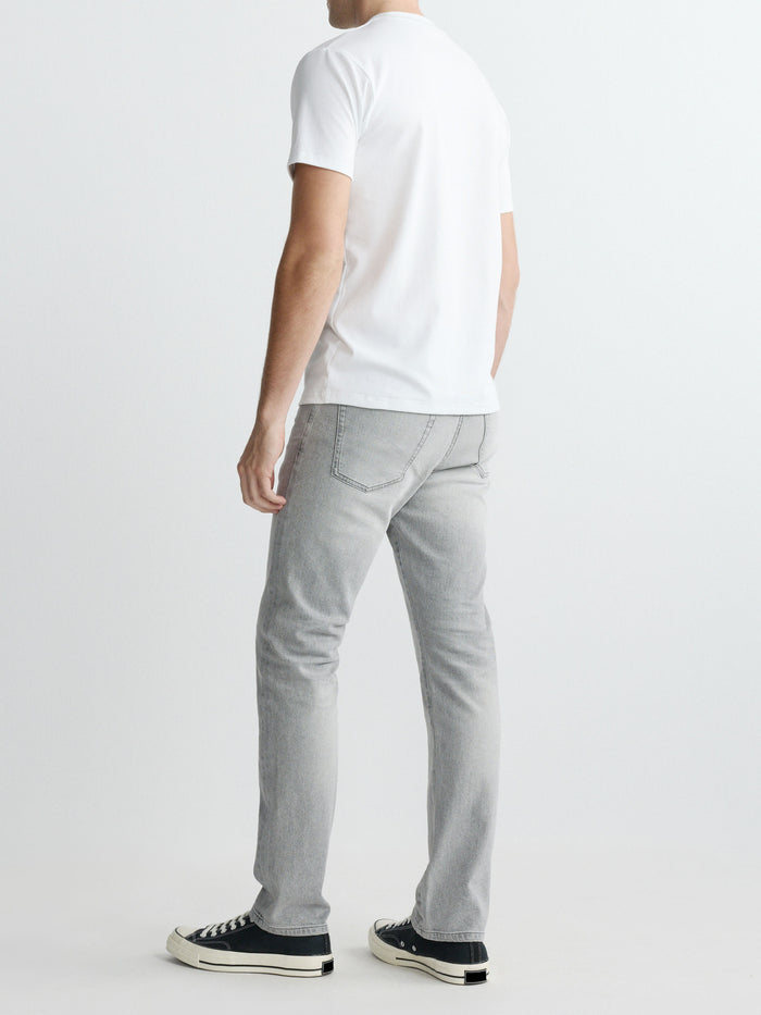 DL1961 men's ribbed crewneck tee in white 'White', back full-length on-model with grey jeans.