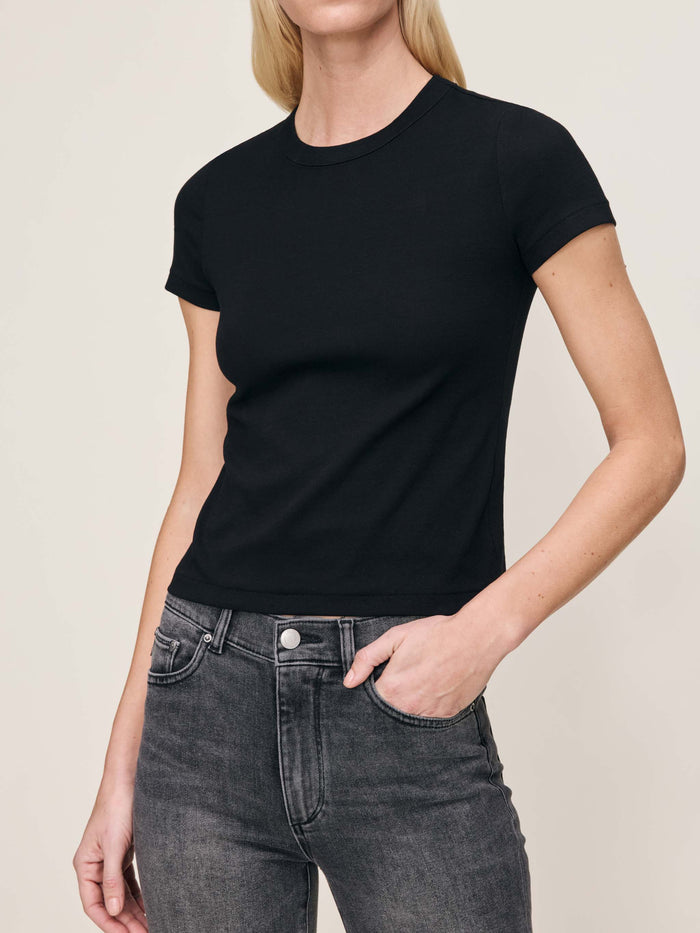 DL1961 Shrunken Tee in black, fitted crew-neck short-sleeve tee, front three-quarter view, hand in grey jeans pocket.