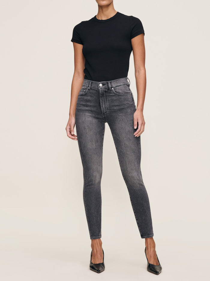 DL1961 Shrunken Tee in black, fitted crew-neck tee styled with grey skinny jeans and heels, full-length front view.