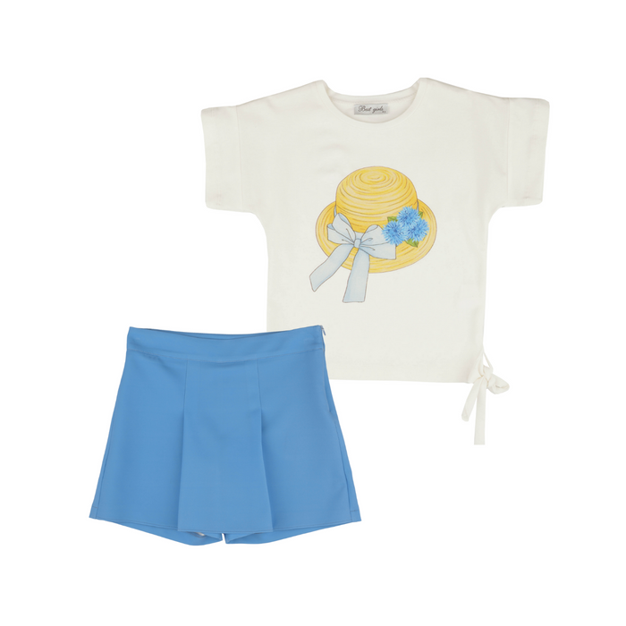 Girls’ outfit with white T-shirt featuring a yellow hat graphic and blue flower accents, paired with bright blue pleated shorts.