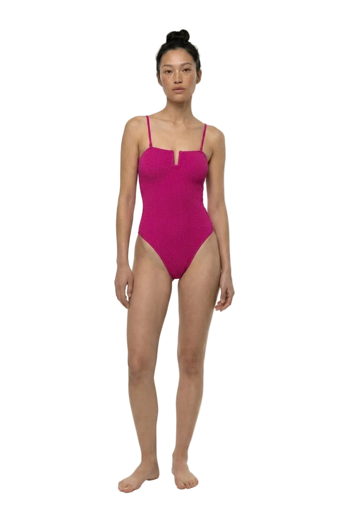 Woman wearing a pink swimsuit on a white background