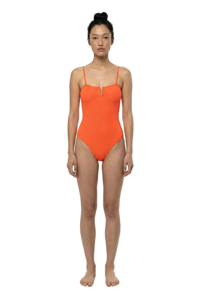 Person wearing an orange swimsuit on a white background