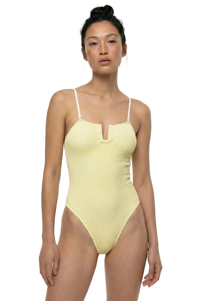 Woman wearing a yellow swimsuit on a white background