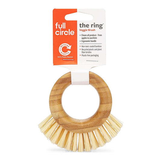 The Ring Veggie Brush by Full Circle, featuring a natural bamboo ring handle and soft natural bristles, attached to its orange and white retail card packaging.